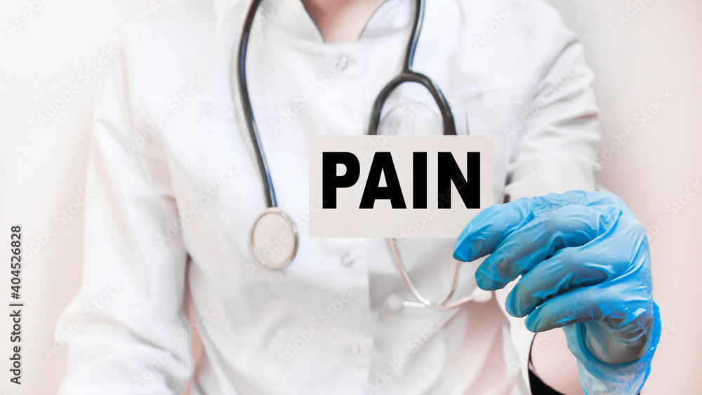 The doctor's blue - gloved hands show the word PAIN - . a gloved hand on a white background. Medical concept. the medicine The doctor's blue - gloved hands show the word PAIN - . a gloved hand on a white background. Medical concept. the medicine
