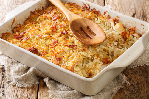 Rappie Pie is a French Canadian dish made of potatoes and meat close-up in a baking dish on the table. horizontal photo