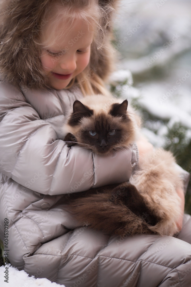 Girl with cat in winter in the garden Girl with cat in winter in the garden
