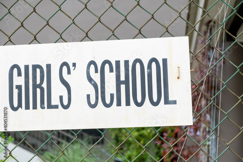 Girls School sign on fence. Stock Photo.