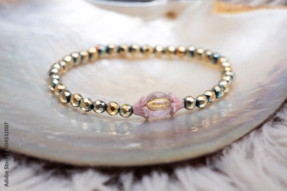Mineral stone beads bracelet on neutral natural background Mineral stone beads bracelet on neutral natural background