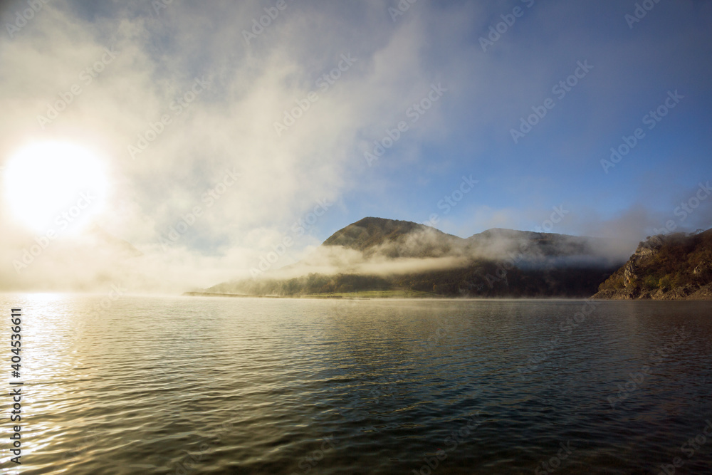 A foggy day at Lake Turano. The colors of autumn in Castel di Tora in Rieti