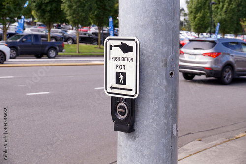 Crossroads. A steel pole with a switch for pedestrians. photo