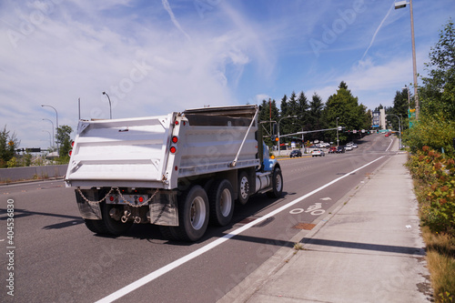 Truck (dumper) in urban traffic. A city in the USA. State Washington.