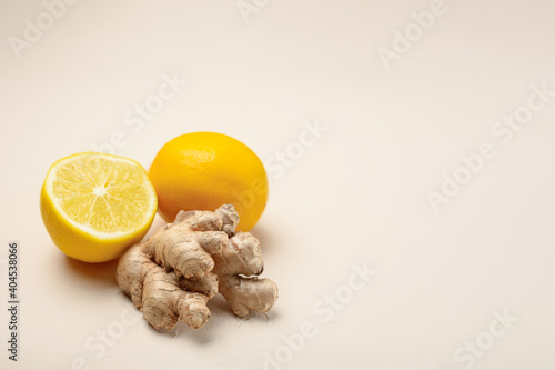 Close-up of ginger and lemon on a light beige background with copy space photo