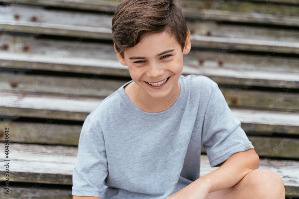 Portrait of teenager outdoors on blurred background