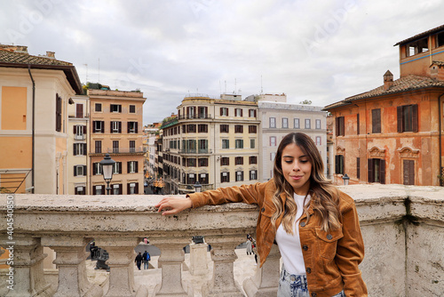 Happy woman standing over an Italian square