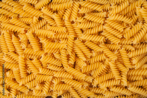 Close-up raw pasta background. Spiral Wheat Pasta