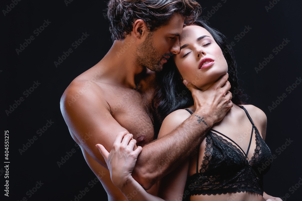shirtless man hugging neck of sexy woman in lace bra isolated on black shirtless man hugging neck of sexy woman in lace bra isolated on black