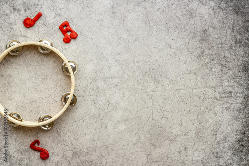 Tambourine with music hotes, flat lay, top view photo