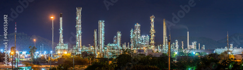Oil refinery with water vapor in Hamburg, Germany, petrochemical industry at night.