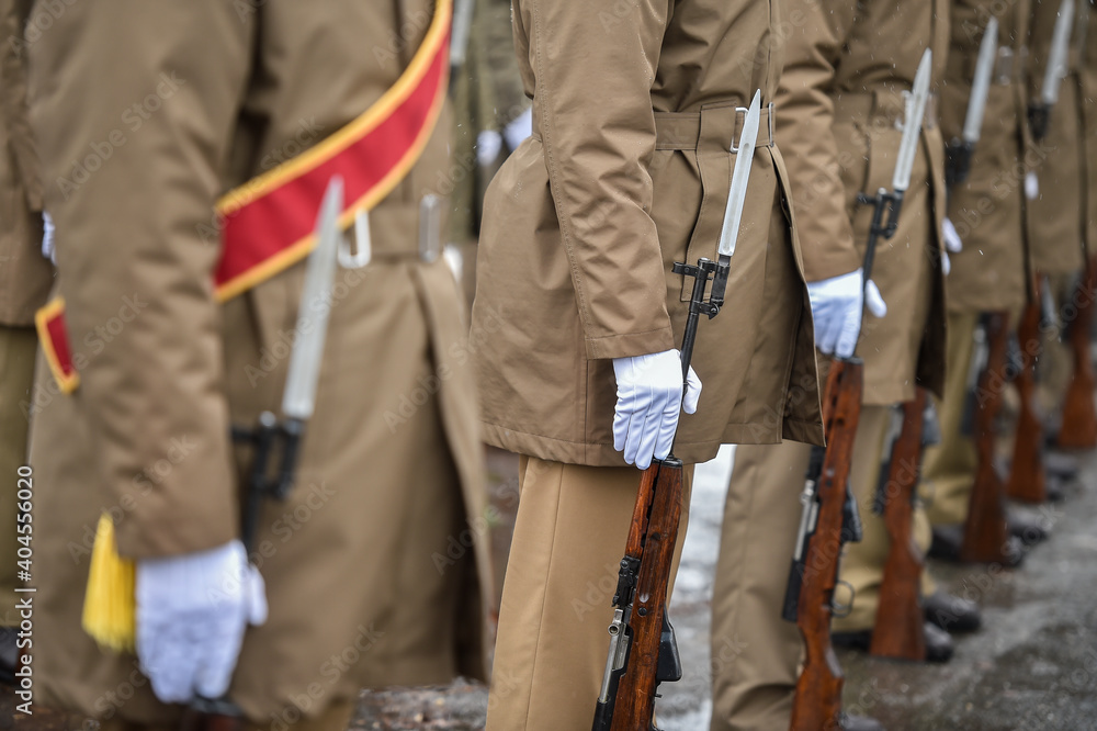 Military guard of honor holding rifles in rest position participate at a funeral in winter time Military guard of honor holding rifles in rest position participate at a funeral in winter time