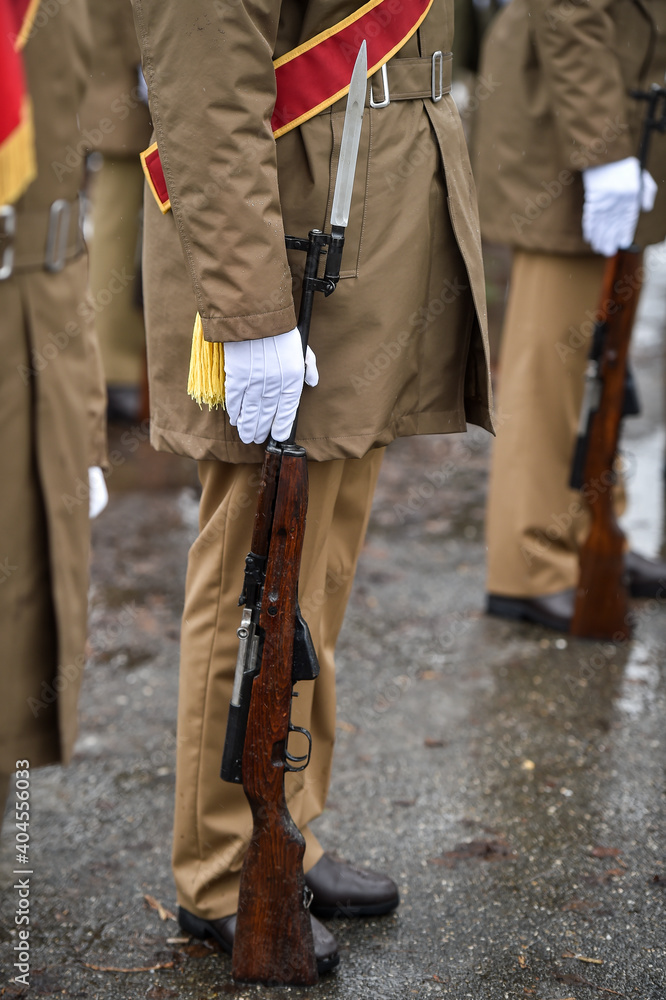 Military guard of honor holding rifles in rest position participate at a funeral in winter time Military guard of honor holding rifles in rest position participate at a funeral in winter time