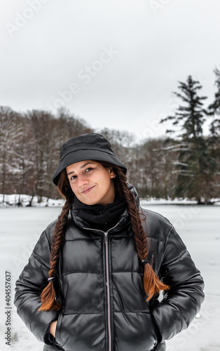 young woman enjoying the snow in a forest in Denmark using warm clothes