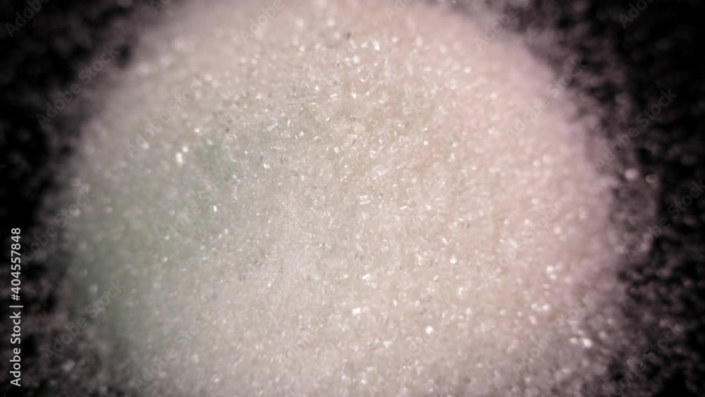 Sugar close-up. Granulated sugar on a black tray. White death. Diabetes Sugar close-up. Granulated sugar on a black tray. White death. Diabetes