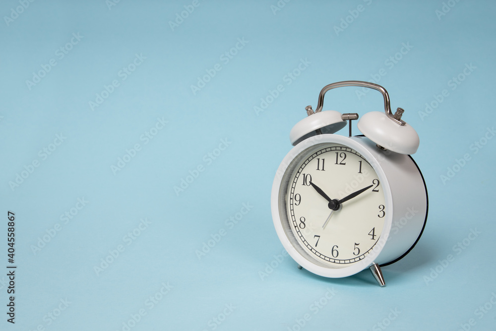 Retro alarm clock on blue background. Old fashioned alarm clock Retro alarm clock on blue background. Old fashioned alarm clock
