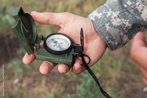 Man with compass in hand outdoor. Travel concept.