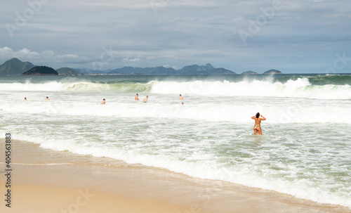   Citizens swim and sunbathe on the beach of Copacabana © Aleksandr