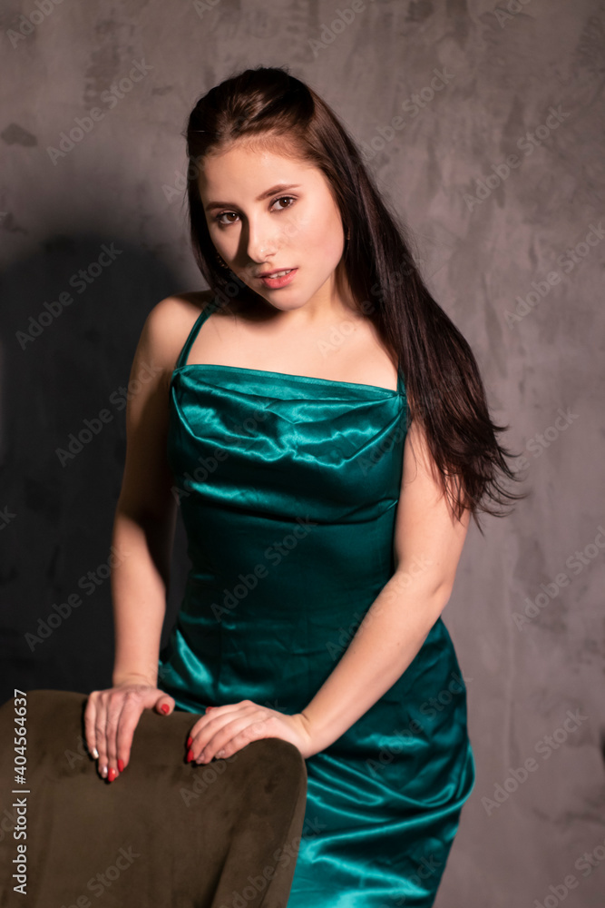 sexy attractive brunette woman in elegant green aquamarine dress in a loft cafe. beautiful sensual girl sexy attractive brunette woman in elegant green aquamarine dress in a loft cafe. beautiful sensual girl