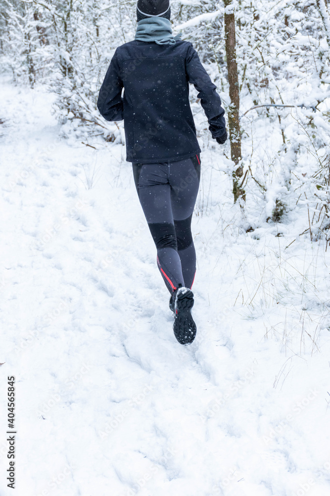 Adult person running in the snow Adult person running in the snow