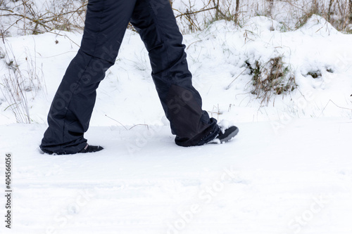 Selected focus. Person walking in the snow. Concept of skiers. Running, trail, climbing, winter crossing.