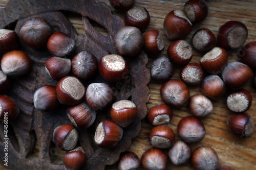 Top view Hazelnuts in nutshell, cracked nuts, wooden background. 