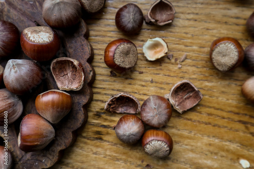 Top view Hazelnuts in nutshell, cracked nuts, wooden background. 