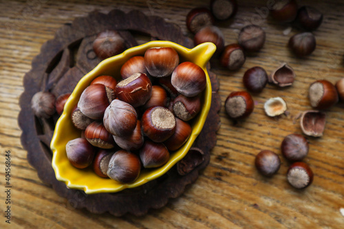 Heap hazelnuts on wooden board wooden background, selective focus with shallow depth of field 