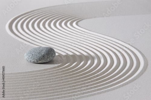Japanese zen garden with stone in textured sand photo