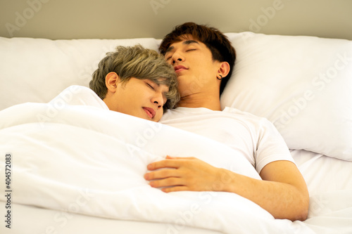 same sex couple lovers LGBTQ lying on bed together 