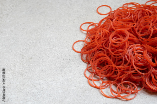 Big red circle rubber bands on a gray background with space to insert text.
