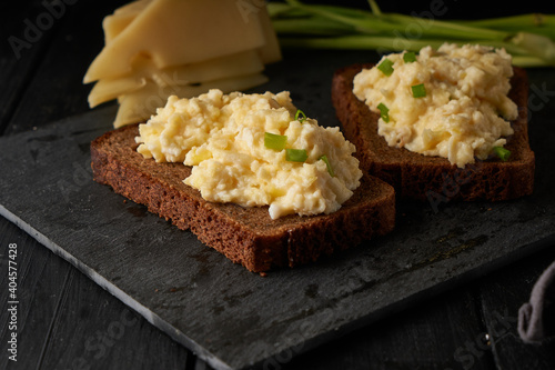 Scrambled eggs with green onion with gluten free bread on table