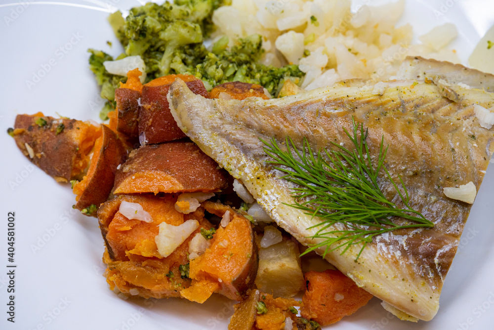 Boiled fish, sweet potatoes, broccoli, cauliflower, healthy food on plate