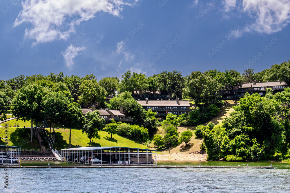 Houses and docks on the shore of Grand Lake Oklahoma - View over water on sunny summer day