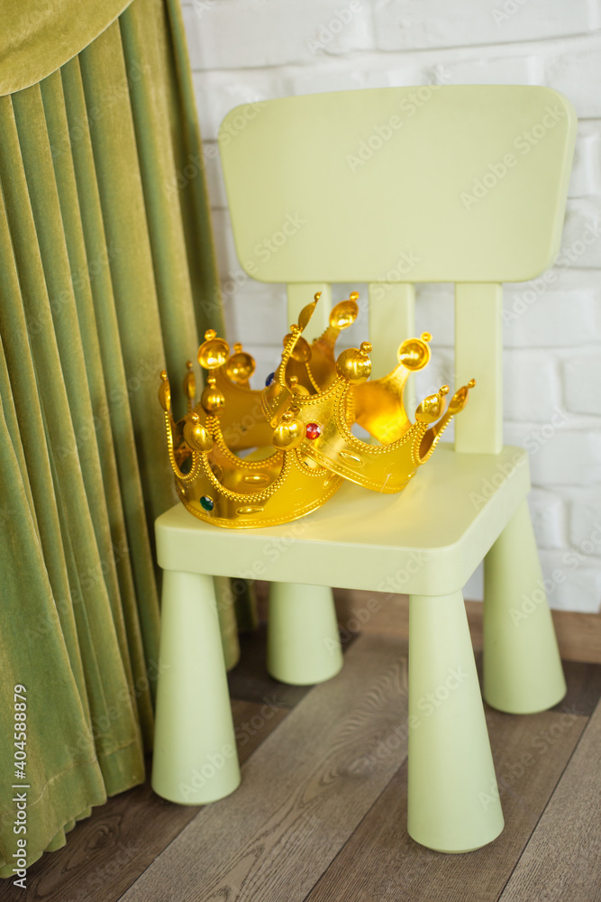 Golden crown on a chair. Birthday party