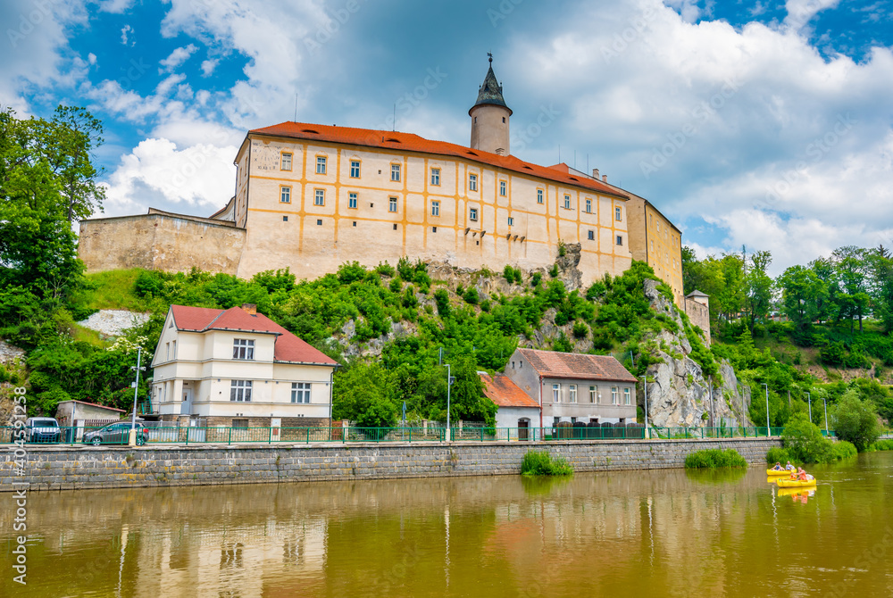 Panoramic view of castle above river in Ledec nad Sazavou. Sazava river is famous target for kayaking. Summer weather with dramatic clouds. Czech Republic.