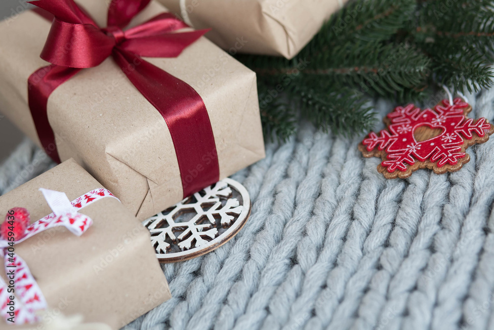Gift boxes with ribbons on a handmade knitted cozy background. Christmas and New year concept. Valentine's Day presents. Happy Birthday. Gift boxes with ribbons on a handmade knitted cozy background. Christmas and New year concept. Valentine's Day presents. Happy Birthday.