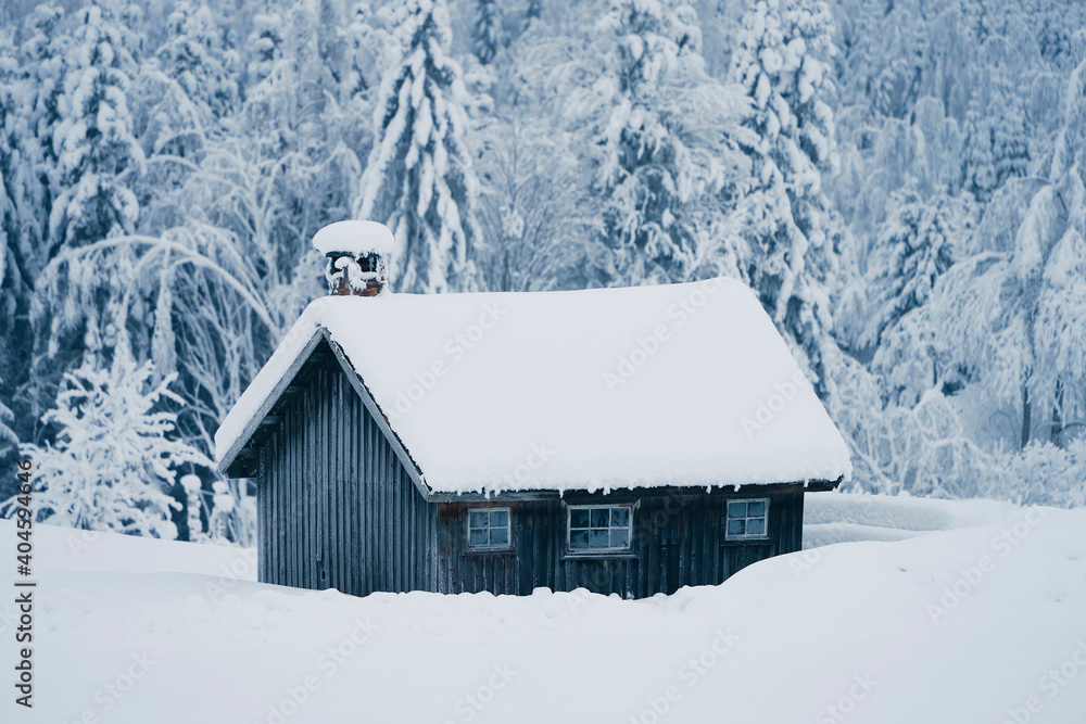 wooden house in the snow, used as rough kitchen on farms in old times