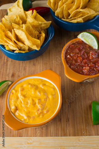 Cheese dip. Queso dip. Melted cheeses mixed with spices and hot sauce. Served with homemade tortilla chips avocado and meat.  Traditional classic Tex-Mex or Mexican restaurant appetizer favorite
