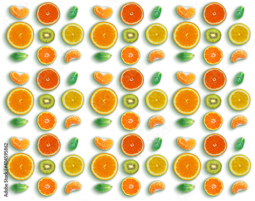 Pattern made with fresh Mandarins, sliced oranges, kiwi and mint leaves on white background. Flat lay