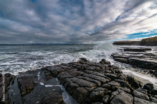 The Atlantic ocean waves crashing in to the cliffs off the west coast of Ireland, County Donegal,  Creavy pier
