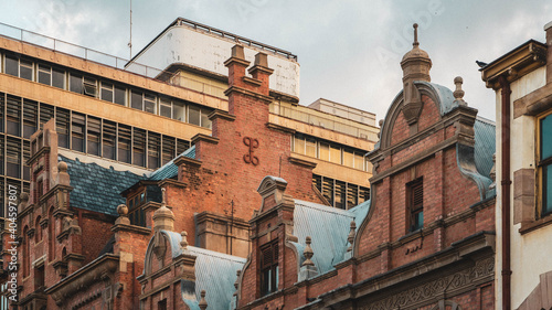 Classic Vintage old building with Modern building behind it 