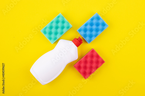 cleaning products display nolling on a yellow background, top view