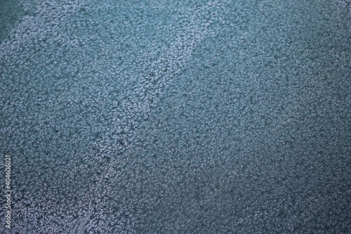Hoarfrost on car windshield as natural gray-blue background or texture