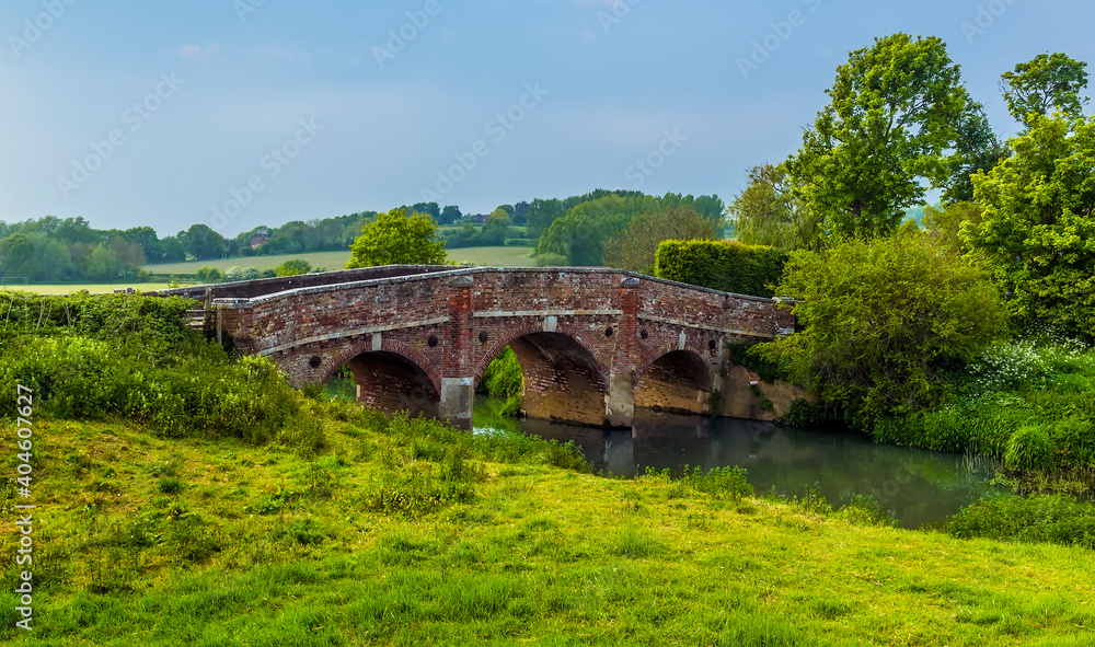 A view from the levy beside the river Rother towards the old bridge at Bodiam, Sussex in springtime A view from the levy beside the river Rother towards the old bridge at Bodiam, Sussex in springtime