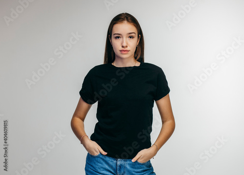 Stylish girl wearing black t-shirt posing in studio