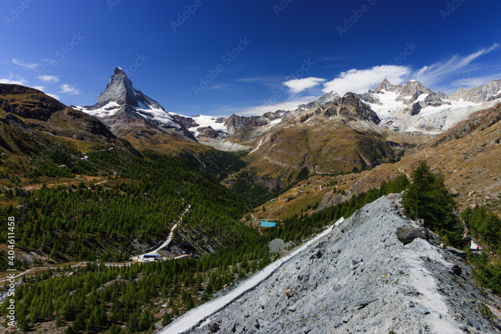 Matterhorn view with shining sun on a good summer day and clouds