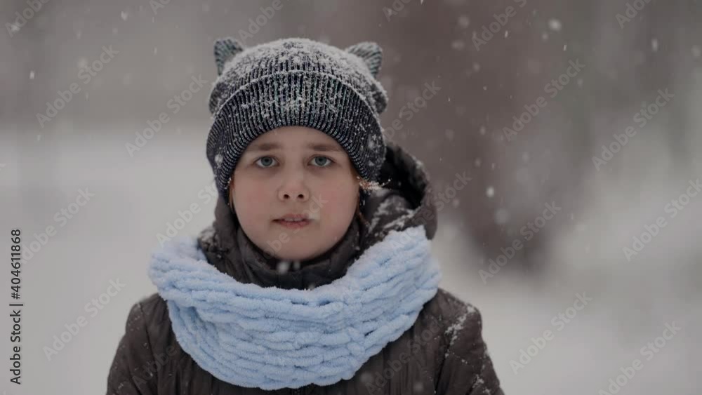 portrait of a cute little girl in a hat and jacket outdoors on a winter day, snowy weather in the park. portrait of a cute little girl in a hat and jacket outdoors on a winter day, snowy weather in the park.