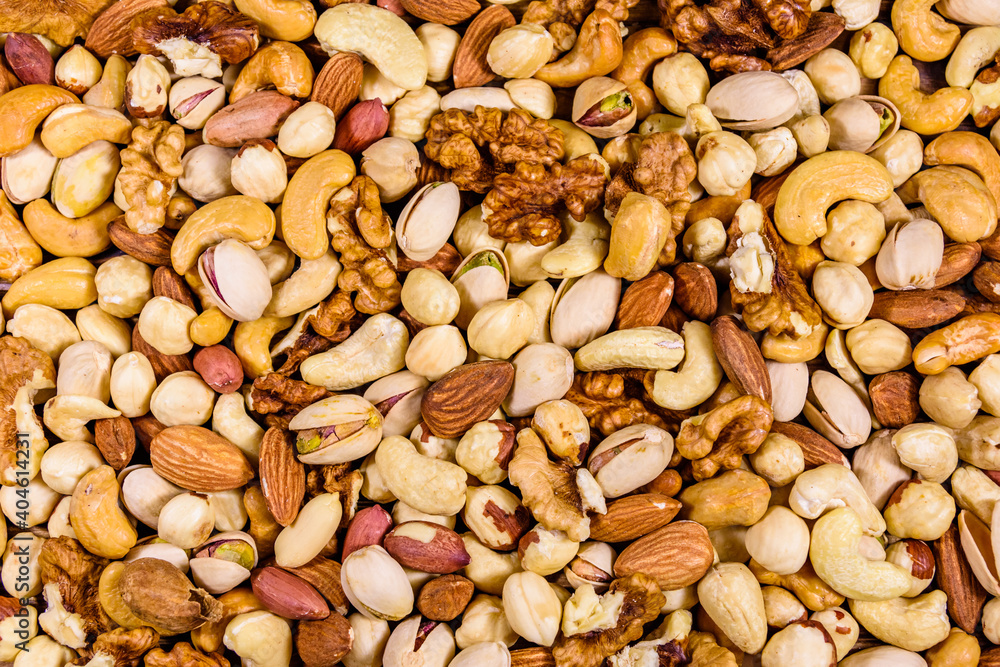 Background of the various nuts (almond, cashew, hazelnut, pistachio, walnut). Vegetarian meal. Healthy eating concept Background of the various nuts (almond, cashew, hazelnut, pistachio, walnut). Vegetarian meal. Healthy eating concept