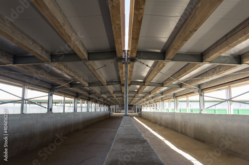 Close-up view of the connection of metal and wooden beams. Steel roof frame under construction. The interior of a big industrial building or factory with steel constructions.